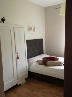 a bedroom with a bed with a headboard at Jaukus butas Šiaulių miesto centre in Šiauliai