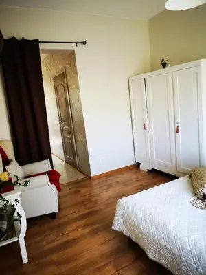 a bedroom with a bed and a door to a closet at Jaukus butas Šiaulių miesto centre in Šiauliai