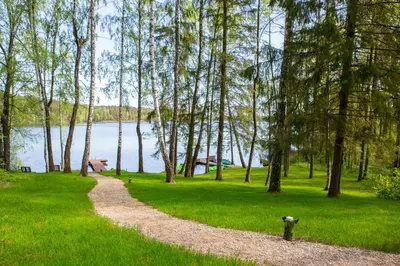 a gravel path in a park with a fire hydrant at Ažuluokesos sodyba in Molėtai