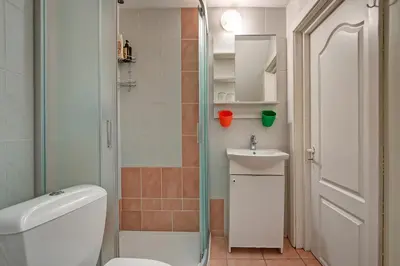 a bathroom with a shower and a toilet and a sink at Vidos Apartamentai in Vilnius