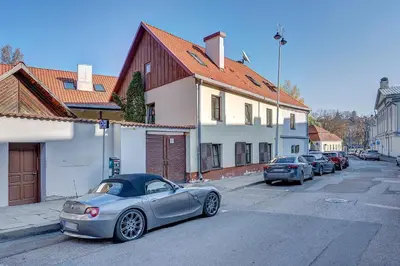 a silver car parked on the side of a street at Vidos Apartamentai in Vilnius