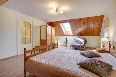 a bedroom with a large bed with two pillows on it at Vidos Apartamentai in Vilnius