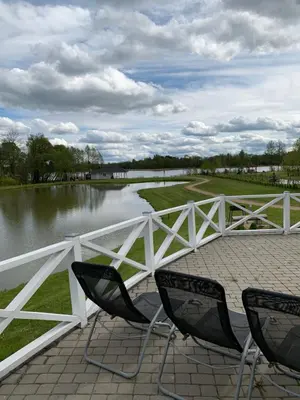 two chairs sitting next to a fence and a river at Vila Bianca in Inturkė