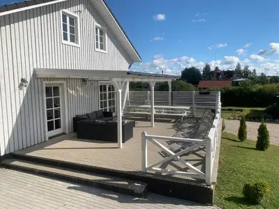 a deck with a couch and a bench on a house at Vila Bianca in Inturkė