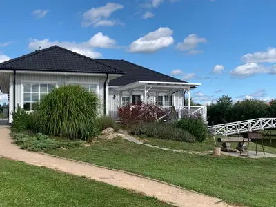 a white house with a black roof at Vila Bianca in Inturkė