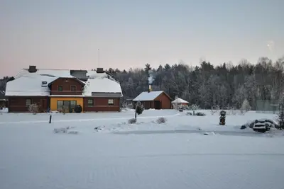 a house is covered in snow in front at Girele in Šiauliai