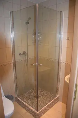 a shower with a glass door in a bathroom at Girele in Šiauliai