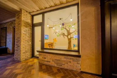 a window of a store with a tree in it at Hotel - Bar Grafaite in Šiauliai