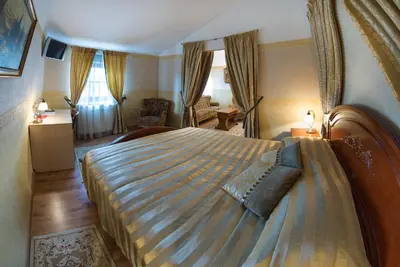 a bedroom with a large bed in a room at Hotel - Bar Grafaite in Šiauliai