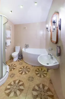 a bathroom with a tub and a sink and a toilet at Hotel - Bar Grafaite in Šiauliai