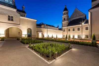 a building with a bunch of plants in a courtyard at Domus Maria in Vilnius