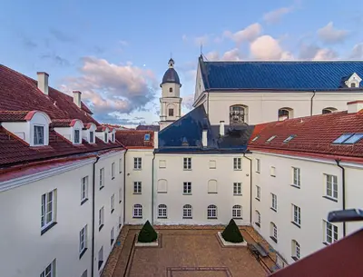 a large white building with a clock tower on top at Domus Maria in Vilnius