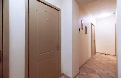 a hallway with a door and a tile floor at Mara in Vilnius