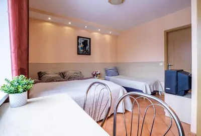 a hotel room with two beds and a tv at Mara in Vilnius