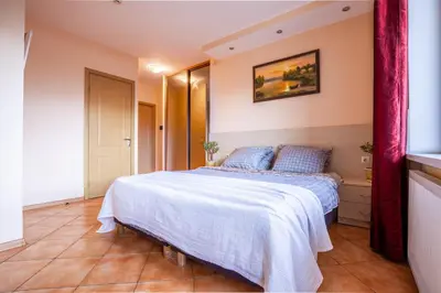 a bedroom with a bed with a white blanket at Mara in Vilnius