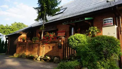 a brick building with flowers on the side of it at Pas Birute in Kaunas