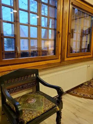 a chair sitting in front of a window at Pas Birute in Kaunas
