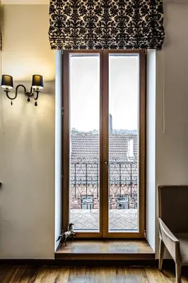 a window with a view of the city at Apartment with a Terrace over the Old Town Two Bedrooms in Kaunas