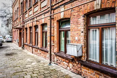 a brick building with windows on the side of it at Apartment with a Terrace over the Old Town Two Bedrooms in Kaunas