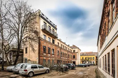 a group of cars parked in front of a building at Apartment with a Terrace over the Old Town Two Bedrooms in Kaunas