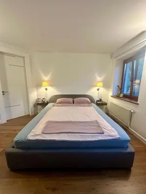 a large bed in a room with two lamps at Apartment with a Terrace over the Old Town Two Bedrooms in Kaunas