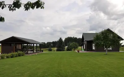 a house with a large yard with a gazebo at Sodyba Puodžių Kaimas in Mackėnai