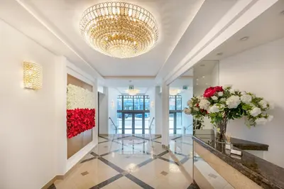 a lobby with a large chandelier and flowers on the wall at Kesminta Šalčininkai in Šalčininkai