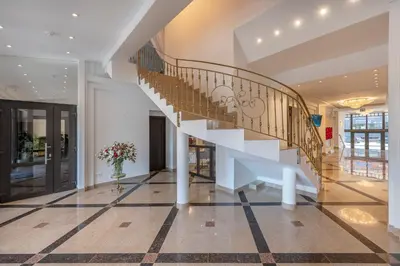 a staircase in a building with a vase of flowers at Kesminta Šalčininkai in Šalčininkai