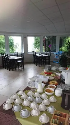 a table with cups and dishes on top of it at Vijuandra in Zarasai