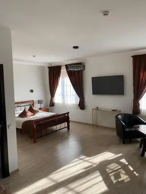 a bedroom with a bed and a flat screen tv at Prie Žiedo in Trakai