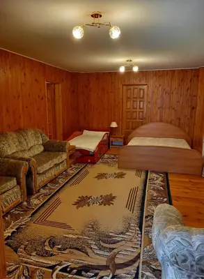 a living room with two beds and a couch at Aido ir Jovitos sodyba Jorunas in Kernavė
