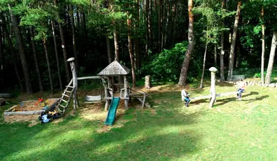 two children playing in a park with a playground at Aido ir Jovitos sodyba Jorunas in Kernavė