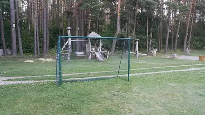 a swing set in a park with a playground at Aido ir Jovitos sodyba Jorunas in Kernavė