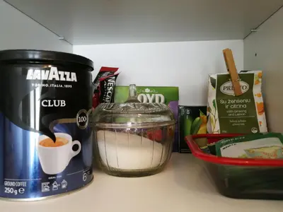 a kitchen counter with a food processor and a cup of coffee at Šiauliai City Apartment in Šiauliai