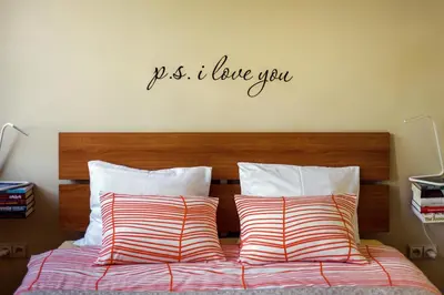 a bedroom with a bed with a sign on the wall at #stayhere - Cozy & Comfy 1BDR Apartment Vilnius Old Town in Vilnius