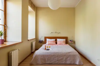 a bedroom with a large bed with orange pillows at #stayhere - Cozy & Comfy 1BDR Apartment Vilnius Old Town in Vilnius