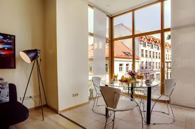a dining room with a table and chairs and a window at #stayhere - Cozy & Comfy 1BDR Apartment Vilnius Old Town in Vilnius