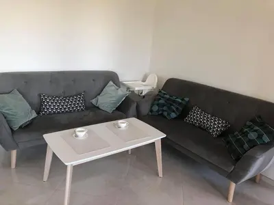 a living room with a couch and a coffee table at Villa Ievynė in Paežeriai