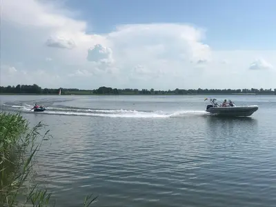 a group of people on a boat in the water at Villa Ievynė in Paežeriai