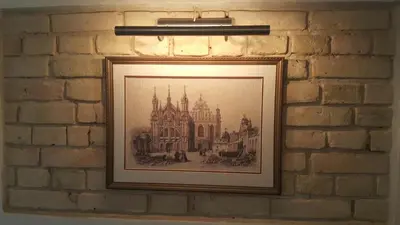 a painting of a castle on a brick wall at Apartment on Kudirkos 20 in Vilnius