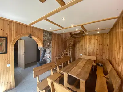 a dining room with a wooden table and chairs at Villa in Vistytis in Vištytis