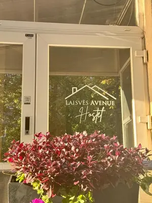 a sign in the window of avenue at Laisves Avenue Hostel 