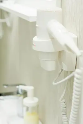 a white phone hanging on a wall in a room at 9010 Apartments in Vilnius