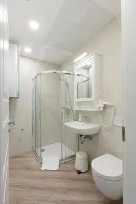 a bathroom with a shower and a toilet and a sink at 9010 Apartments in Vilnius