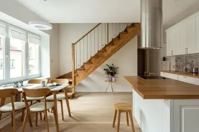 a kitchen with a table and chairs and a staircase at #stayhere - Spacious 2BDR Two Floor I Heart of Old Town in Vilnius