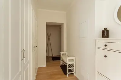 a white kitchen with a stair case in a room at #stayhere - Spacious 2BDR Two Floor I Heart of Old Town in Vilnius