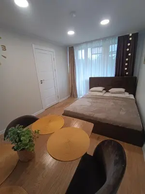 a bedroom with a bed and two tables and chairs at Dariaus ir Girėno 6 Apartments in Vilnius