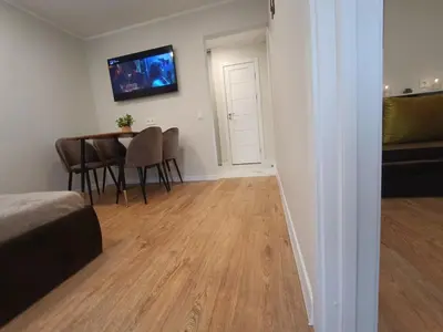 a room with a table and chairs and a dining room at Dariaus ir Girėno 6 Apartments in Vilnius