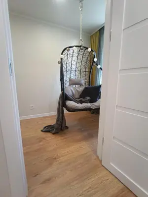 a room with a rocking chair in a hallway at Dariaus ir Girėno 6 Apartments in Vilnius