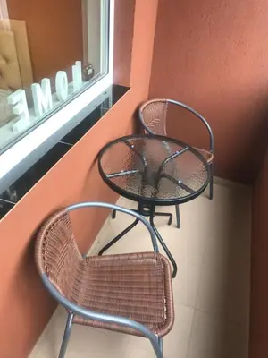 a table and chair sitting next to a window at Trumpalaikė buto nuoma Rokiškyje su jacuzzi in Rokiškis